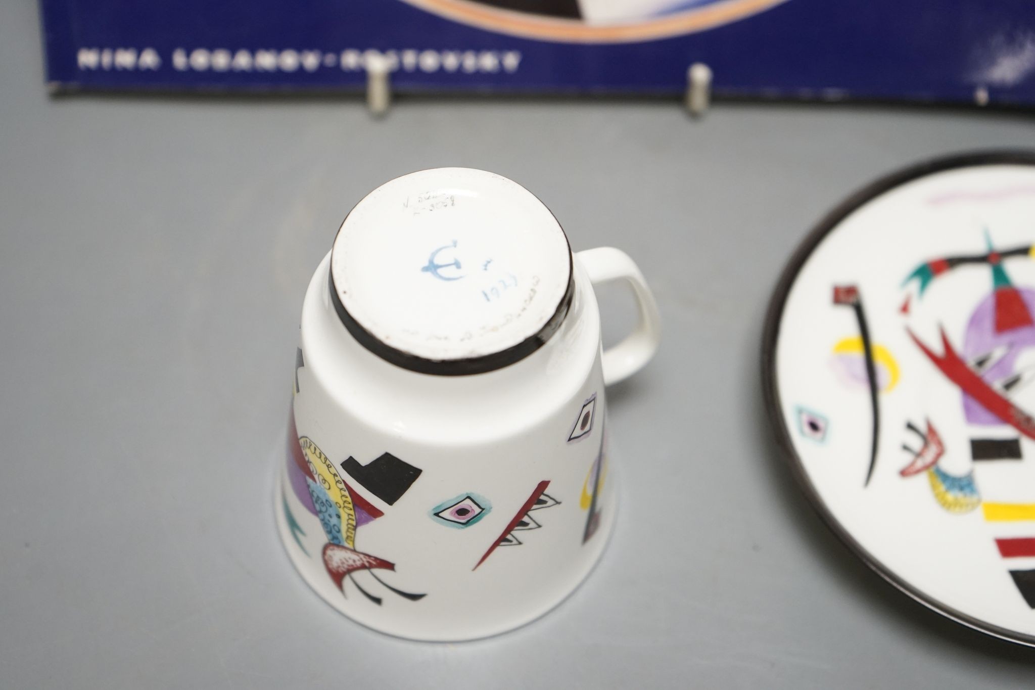 Russian Suprematist-style coffee cup and saucer, 20th century, together with a volume of Revolutionary Ceramics by Nina Lobanov-Rostovsky